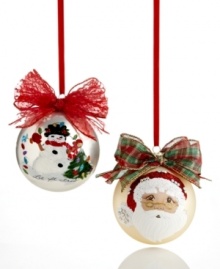 Treasure the hand-painted charm of Kurt Adler's Sarabella ball ornaments. A festive winter scene topped with a shimmering red bow and Santa's face shining on matte gold glass bring something special to your tree.