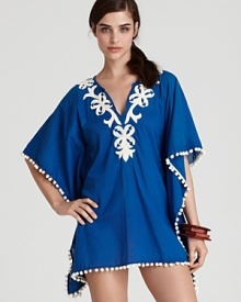 This caftan-style coverup from Ondademar features bohemian embroidery and pom-pom trim. Add a vibrant silk scarf for a head-to-toe holiday look.