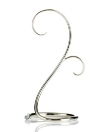 With a few twists of gleaming, silvertone metal, this Swarovski ornament stand holds and displays the accents that warm your heart. A single crystal adds a touch of sparkle to its base.