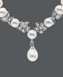 Cultured freshwater pearls (5.5-6mm) are paired with 14k white gold floral accents and shimmering diamond accents. Length measures 18 inches.