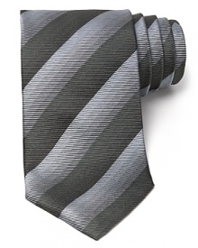 Thin tonal stripes dash across this handsome tie, rendered in luxurious Italian silk for classic opulence.