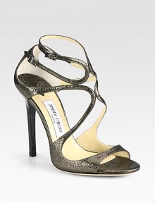 Shimmering metallic leather forms this iconic strappy silhouette with a lustrous high-heel. Lacquered heel, 4½ (115mm)Metallic leather upperAdjustable ankle strapsLeather lining and solePadded insoleMade in ItalyOUR FIT MODEL RECOMMENDS ordering one half size up as this style runs small. 