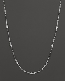 A white gold necklace with bezel-set diamond stations. With signature ruby accent. Designed by Roberto Coin.