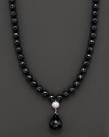 A dramatic black onyx and fresh water pearl necklace with faceted teardrop onyx centerpiece.