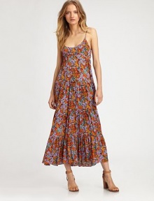 Slightly shirred maxi silhouette in a dainty floral print with a low back and slight hi-low hem. ScoopneckSpaghetti strapsLow backHi-low ruffle hemAbout 46 from natural waist53% viscose/47% rayonDry cleanImportedModel shown is 5'10 (177cm) wearing US size Small.