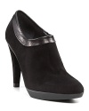 Low-slung, but not short on style, these sumptuous suede booties flaunt luxe leather trim. By Stuart Weitzman.