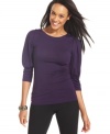 Puffed sleeves and buttoned shoulders take this three-quarter-sleeve top by AGB from basic to beautiful.