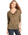 This sleek cowl-neck top from MICHAEL Michael Kors features an earth-tone feather print and is the perfect way to update your favorite denim.