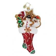 Festive cookies accented in glitter are stashed in a candy cane adorned stocking.