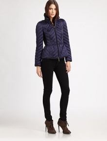 This sporty, quilted puffer style features a slightly flared peplum and crisp contrast piping.Stand collarEpaulettesZip frontContrast pipingContrast side panelsBack button tabsFully linedAbout 23 from shoulder to hemPolyesterImportedModel shown is 5'10 (177cm) wearing US size Small. 