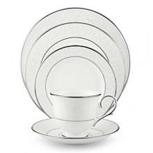 With enameled pearl-like dots, an opalescent background, and the innocence of bone china, Opal Innocence is a romantic pattern of understated elegance. Two bands of platinum a slightly wider one on the rim, kissing a thin fluted design, and a narrower one inside the border adorn each plate. The cup bears additional platinum on its graceful handle and another band at midpoint. Each piece is decorated with a flowing, white-on-white vine design peppered with enamel dots. This service creates a splendid formal table setting and, because of its neutral coloring, works well with any table décor.