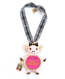 Think pink. Show off your playful side with Betsey Johnson's pink pig picture frame ornament. Accessorized with a bow and pearl necklace and carrying a wrapped present, it's adorned with sparkling crystal accents. Made in gold tone mixed metal, it hangs from a gingham ribbon. Approximate length: 2-3/4 inches. Approximate drop: 4-1/4 inches.