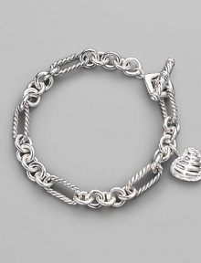 From the Cable Heart Collection. A lovely cable heart framed in pavé diamonds hangs from a figaro chain bracelet of sterling silver. Diamonds, 0.19 tcw Sterling silver Length, about 7½ Toggle closure Imported