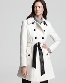 A military-inspired DKNY coat flaunts faux leather details and a two-tone belt for a fashion-forward look that's truly eye-catching. Work the on-trend silhouette with your workday ensembles and master this editorial favorite.