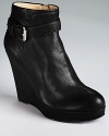 Bold and buckled, DKNY's wedged ankle booties go downtown when teamed with dark grey skinnies and a hardware-heavy handbag.