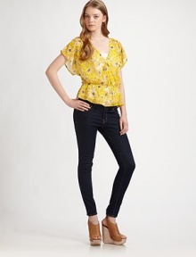 This cheery floral top offers a figure-flattering fit with cinched waist and feminine butterfly sleeves. Cross-over v-neckDropped shouldersShort butterfly sleevesDrop elasticized waistRuffle hemSilkDry cleanImportedModel shown is 5'10 (177cm) wearing US size Small.