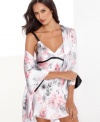 Effortless elegance. Caress your shoulders with the floral print of this flowing satin wrap by Jones New York.