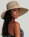 Make a sparkling statement in a braided floppy hat with woven metallic fibers.