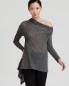 Rendered in lightweight wool, this sheer Donna Karan New York turtleneck tunic flaunts a flared body and asymmetric hem for a modern take on a classic style. Effortless with leggings for the weekend or a pencil skirt for workdays, it's your new versatile go-to.