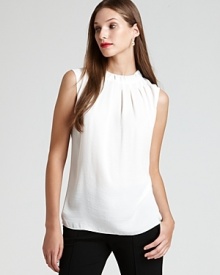 A careerist essential, the classic white AK Anne Klein blouse gets a feminine update with a delicately pleated neckline and graceful tie back.