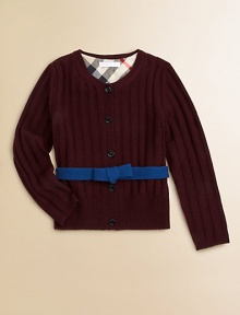 A wide ribbed texture and a contrast ribbon with a bow give this merino wool sweater its pretty panache.Round ribbed necklineLong sleeves with ribbed cuffsContrast attached self beltButton placketWide ribbed hemMerino woolDry cleanImported Please note: Number of buttons may vary depending on size ordered. 