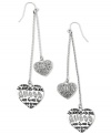 Accessorize with lovely style. These GUESS linear earrings swing with heart charms detailed with jet epoxy logos and crystal accents. Crafted in silver tone mixed metal. Approximate drop: 3-1/4 inches.