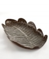 A product of their environment, this large leaf tray is handcrafted by Haitian artisans from recycled steel. Curved edges and intricate detail on its surface lend the one-of-a-kind piece to both use and display.