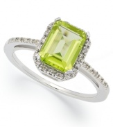 A green sensation. This unique emerald-cut peridot ring (2 ct. t.w.) stands out against a halo of round-cut diamond accents. Set in 10k white gold. Size 5, 5-1/2, 6, 6-1/2, 7, 7-1/2, and 8.