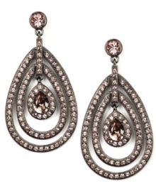 La vie en rose. A delicate rose hue defines these sparkling orbital drop earrings from Givenchy. Adorned with glittering crystals and glass accents, they're crafted in hematite tone mixed metal. Approximate drop: 2-1/4 inches.