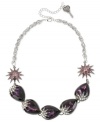 Make a stunning statement with this frontal necklace from Betsey Johnson. Crafted from hematite- and silver-tone mixed metal, the necklace features purple glass crystal accents and gems in teardrop and starburst motifs. Approximate length: 16 inches + 3-inch extender. Approximate drop: 3/4 inch.