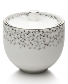 Fringed with shimmering leaves of platinum and mica, this bone china covered sugar bowl turns your table into a springtime utopia. Its sleek shape and smooth lid are a vision of modern elegance in platinum-banded white.