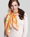 A vibrant silk scarf with large floral Ganini print all over from Salvatore Ferragamo.