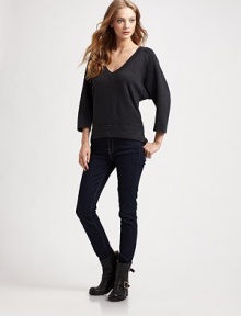 Three-quarter dolman sleeves and a hi-low hem enhance this oversized, wool-rich v-neck with a hint of cashmere. V-neck Three-quarter dolman sleeves Hi-low hem Longer length hits below the hips 40% wool/25% viscose/25% nylon/10% cashmere Dry clean Imported