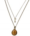 Double up or make a subtle statement. Fossil's chic two-tier pendant can be worn together or one at a time. A petite cut-out key adorns one chain, while a pear-cut tiger's eye stone decorates the other. Set in oxidized brass tone mixed metal. Approximate lengths: 16 inches and 18 inches. Approximate drops: 5/8 inch and 1-1/4 inches.