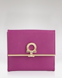 A luxe trifold wallet in textured leather with signature lock detail from Salvatore Ferragamo.