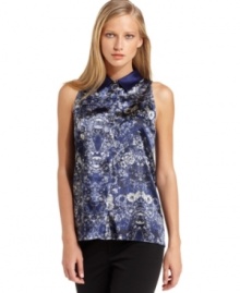 T Tahari's silky printed top looks polished with a solid point collar and buttoned front placket.