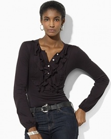 A long-sleeved cotton tee is accented with delicate ruffles at the placket for a feminine twist on a classic.