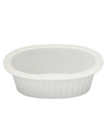 This pristine white serveware features gently scalloped rims and raised patterns of cascading vines. Perfect for casual dining or formal entertaining, this charming oval baker is sure to enhance mealtime at your home. Can go from freezer to oven! From Lenox's dinnerware and dishes collection. Qualifies for Rebate