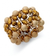 The soothing golden tones lend a graceful touch to this cuff bracelet from Alfani. With teardrop and round glass accents. Crafted in gold tone mixed metal. Approximate length: 7-1/2 inches. Stretches to fit wrist.