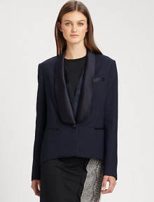 A modern variation on the traditional tuxedo, with feminine touches including an extended satin collar