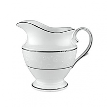 With enameled pearl-like dots, an opalescent background, and the innocence of bone china, Opal Innocence is a romantic pattern of understated elegance. Two bands of platinum a slightly wider one on the rim, kissing a thin fluted design, and a narrower one inside the border adorn each plate. The cup bears additional platinum on its graceful handle and another band at midpoint. Each piece is decorated with a flowing, white-on-white vine design peppered with enamel dots. This service creates a splendid formal table setting and, because of its neutral coloring, works well with any table décor.