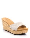 Sleek suede contrasts with fun, summery raffia on these easy slip-on wedges.