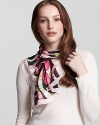 A chic oblong silk scarf with large floral Ganini print all over from Salvatore Ferragamo.