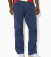 A relaxed-fitting pant in lightweight cotton poplin exudes rugged regality with a button-flap cargo pocket at the leg.