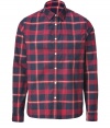 Rugged looks get a cool finish in Woolrichs red and navy plaid button-down - Classic cut, buttoned cuffs, breast pocket, shirttail hemline - Team with jeans and rugged boots