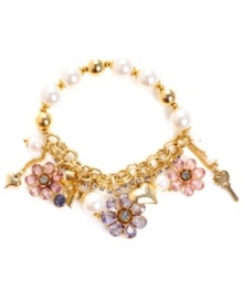 Looking feminine has never felt so effortless. Betsey Johnson's chic stretch bracelet combines sweet flower and heart charms with sparkling purple, blue and pink crystals and glass pearl accents. Set in antique gold-plated mixed metal. Approximate length: 7-1/2 inches.