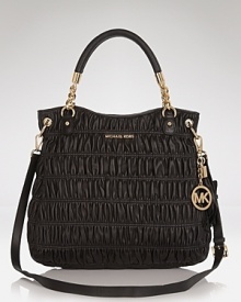 Go both classic and cool with this quilted style from MICHAEL Michael Kors. Featuring a prettified version of a favorite shape - the satchel - this bag lends luxury to every look.