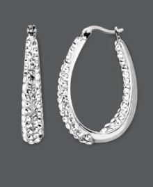 Celebrity-inspired style that will have you looking red-carpet ready. These glamorous Kaleidoscope hoop earrings feature a sparkling in and out design accentuated by clear crystals with Swarovski Elements. Crafted in sterling silver. Approximate diameter: 1-1/10 inches.