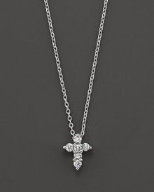 From the Tiny Treasures collection, a diamond Cross necklace makes a religious statement; with signature ruby accent. Designed by Roberto Coin.