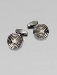 Concentric links of gunmetal-plated metal are polished on the outside and sandblasted in the recessed ridges to enhance the pattern. Gunmetal-plated metal About ½ diam. Made in the United Kingdom 